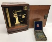 A mahogany cased brass microscope together various lenses,
