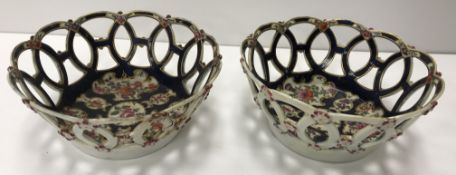 A pair of 18th Century Worcester blue ground floral spray and gilt decorated baskets with relief