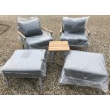 A pair of Bramblecrest aluminium framed garden chairs with teak arms and matching footstools,