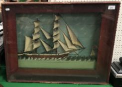 A 19th century glazed diorama as a twin masted sailing vessel in choppy seas 71 cm wide x 55 cm
