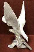 A Lladro figure of a "Seagull with spread wings, on a leafy base", 28.