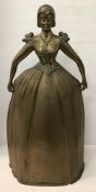 An early 20th Century brass bedroom spark guard of figural form as a woman in crinoline dress,