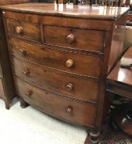 A Victorian mahogany bow fronted chest of two short over three long graduated drawers with turned