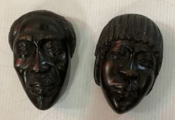 A pair of African carved ebony face masks,