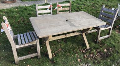 A slatted teak garden table and four chairs,