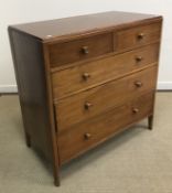 A mid 20th Century teak chest of two short over three long graduated drawers with turned knob