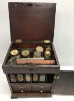 A 19th Century mahogany apothecary box containing various bottles, scales, etc., 23.5 cm wide x 19.