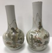 A pair of polychrome decorated Chinese vases each depicting landscape with mountains in background