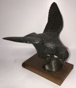 A Japanese Meji period bronze figure of a spreadeagle, one claw upon a rock,