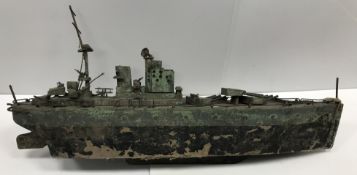 A scratch-built painted wooden model of a World War I battleship with multiple heavy guns and