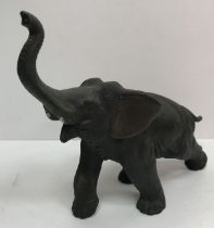 A Japanese Meji period bronze study of an elephant with trunk held aloft bearing script seal mark