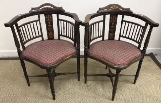 A pair of Edwardian mahogany rosewood and marquetry inlaid yoke back corner chairs with shaped