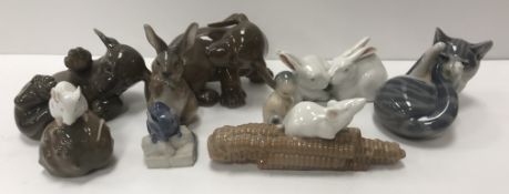 A collection of Royal Copenhagen figures comprising two puppies No'd 1407 and 1408,