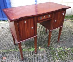 A mahogany oval drop leaf Pembroke table, mahogany serpentine fronted sideboard,