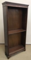 A modern mahogany open bookcase in the Georgian style with adjustable shelving on bracket feet 89