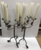A pair of Arts & Crafts style scrolling four light candelabra, 39.