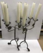 A pair of Arts & Crafts style scrolling four light candelabra, 39.