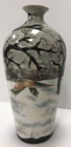 A Cobridge stoneware vase depicting a snow covered landscape with two pheasant initialled "ML" and