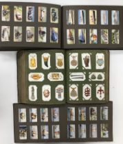 Three vintage albums of cigarette cards to include various mounted sets including British Orders &
