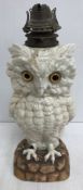 A late 19th Century Continental pottery oil lamp base as an owl set with glass eyes 43 cm including