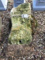 A natural stone staddle stone with top,