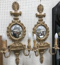 A pair of modern gilt decorated girandole mirrors with convex oval plates and hydra styles finials,