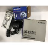 A box of assorted cameras and camera equipment to include an Olympus Camedia C-765 Ultra Zoom,