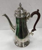A modern silver coffee pot with wooden handle (by C.J. Vander, London 1970) 28.5 cm high, 32.
