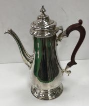 A modern silver coffee pot with wooden handle (by C.J. Vander, London 1970) 28.5 cm high, 32.