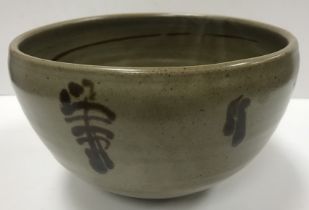 A Ray Finch studio pottery bowl with stylised foliate decoration on a mottled grey ground,