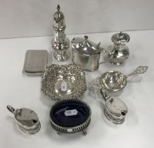 A collection of small silver wares to include a Georgian style baluster pepper,