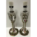 A pair of 19th Century French gilt brass mounted porcelain candlesticks with floral spray