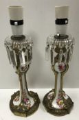 A pair of 19th Century French gilt brass mounted porcelain candlesticks with floral spray
