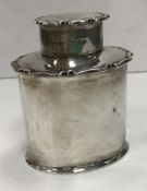 A George V silver oval tea caddy (by Aitken Brothers, Sheffield 1914) 11 cm high, 224 g/7.