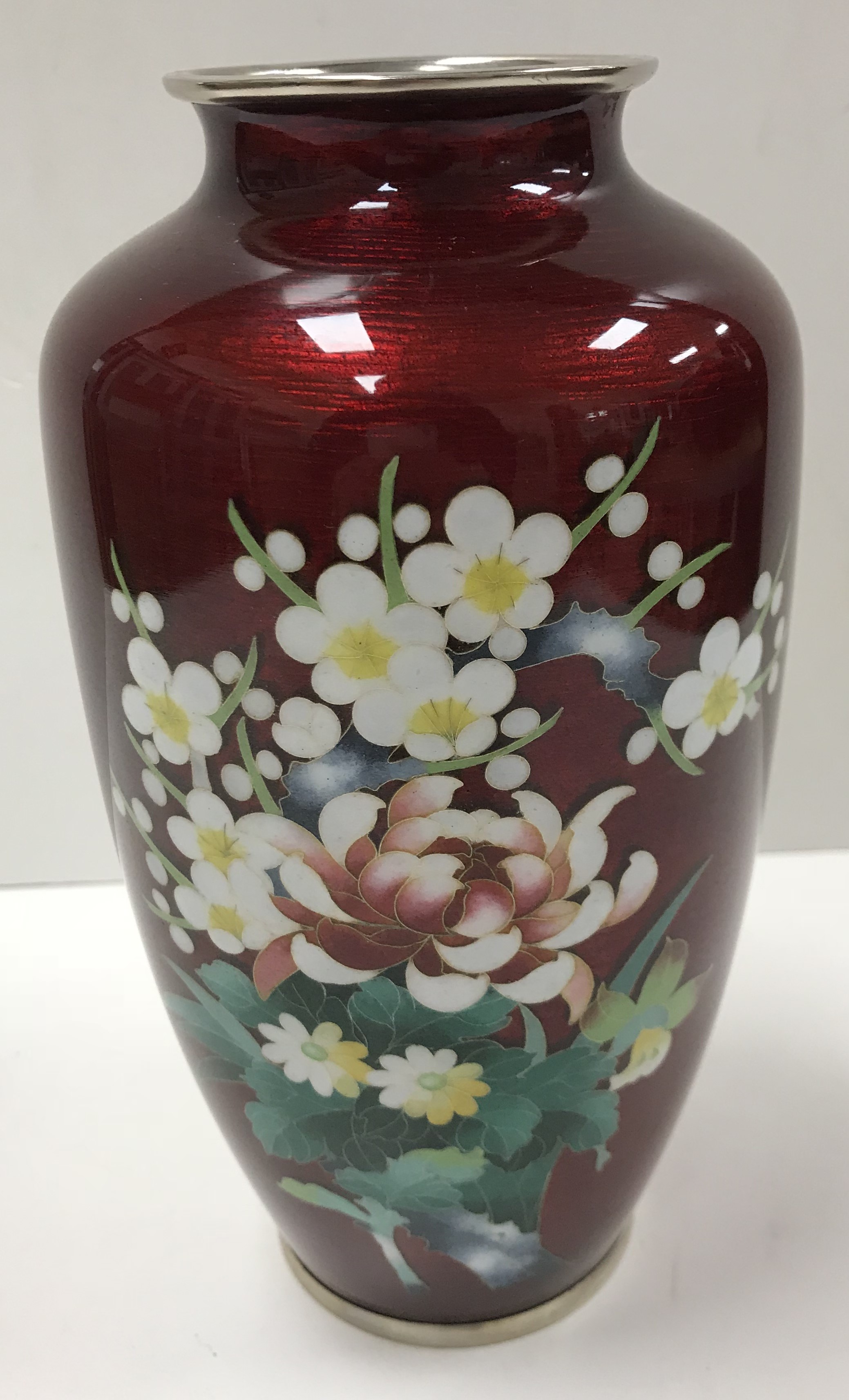 A 20th Century Japanese Ginbari cloisonné vase decorated with floral spray on a red ground raised