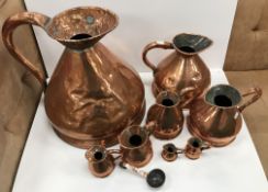 A collection of eight Victorian copper haystack measures comprising 4 gallon, 1 gallon, half gallon,