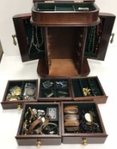 A modern wooden jewellery cabinet / chest containing various jewellery,