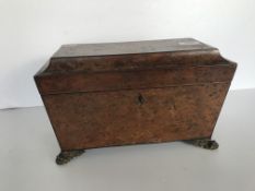 A 19th Century burr yew tea caddy of sarcophagus form,