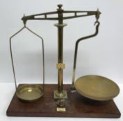 A pair of brass balance scales bearing ivorine label inscribed "S.