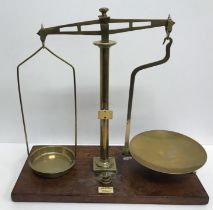 A pair of brass balance scales bearing ivorine label inscribed "S.