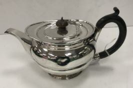 A George V silver teapot with ebonised handles (by Charles Stuart Harris Ltd, London 1910), 13.