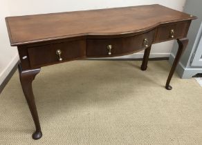 A mahogany break front three drawer side table in the Georgian style raised on cabriole legs to pad