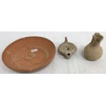 A Roman style pottery oil lamp with serpent decoration to top and impressed mark to base 10 cm long