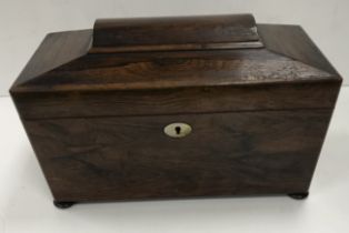 A 19th Century rosewood tea caddy of sarcophagus shaped form,