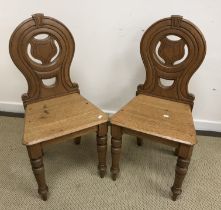 A pair of Victorian oak panel seated hall chairs and an Edwardian mahogany and satinwood strung