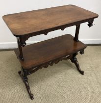 A Victorian rosewood two tier dumb waiter on end pillar supports to moulded cabriole legs to scroll