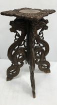 A Chinese carved hardwood dragon and serpent decorated urn or plant stand,