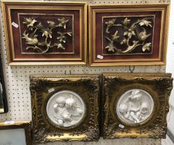 A pair of 20th Century carved foliate decorated panels in red and gilt, including frame 25.