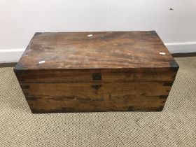 A 19th Century teak brass bound trunk of small proportions 70 cm x 35 cm x 30 cm high together with