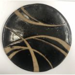 A studio pottery plate in the manner of Soji Hamada, unsigned,